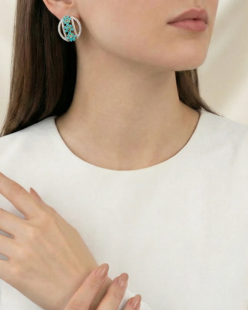 Azure Orb Stud Earrings by Jewel by JF featuring sleek, round earrings with a vibrant blue orb design.