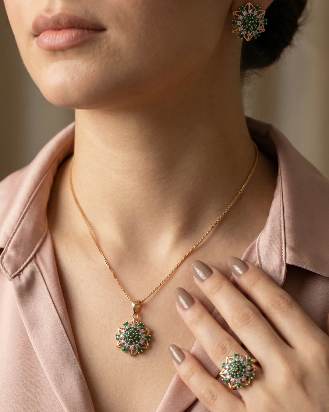 Emerald starburst jewelry set by Jewel by JF featuring earrings and necklace with vibrant emerald stones and intricate design.