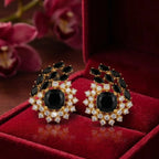 Onyx statement earrings by Jewel by JF featuring bold black onyx stones and sleek silver studs.